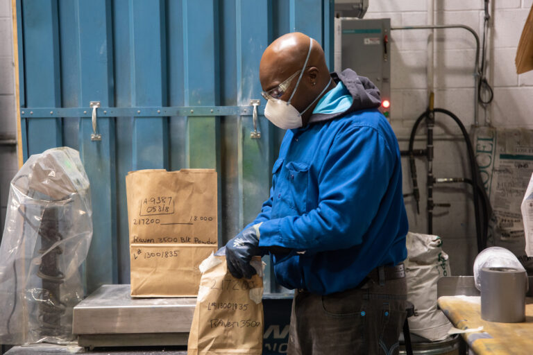 Powder ingredients getting weighed before sending to a production area