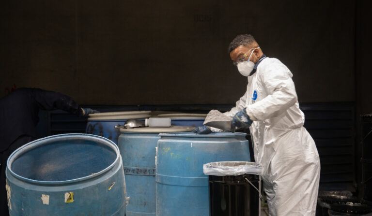 Employee preparing maskant powder